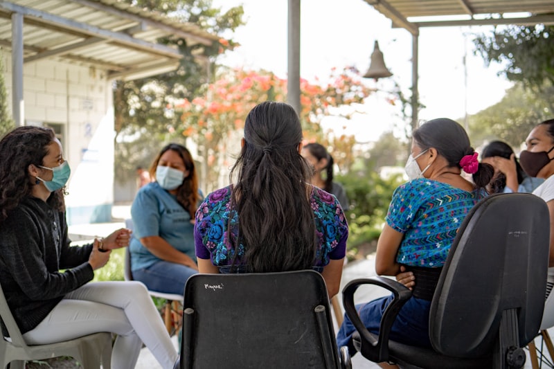 A group of people sitting around each other
