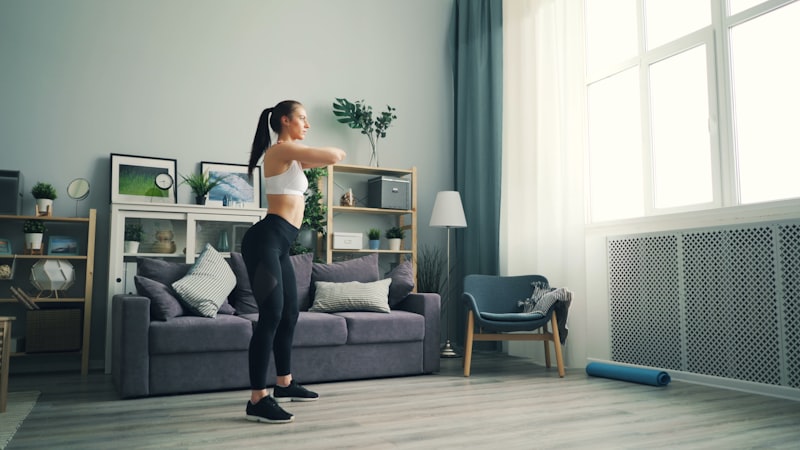 a woman standing in a living room in front of a window