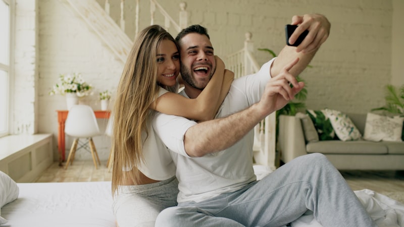 Couple taking a selfie in bed